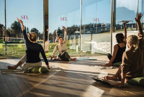 a group of people sitting on the floor doing yoga at San Giovanni Terme Rapolano in Rapolano Terme