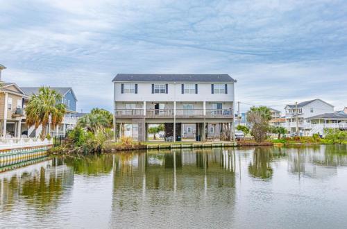 a large house in front of a body of water at Sea Pond Villa Unit 3 in Myrtle Beach