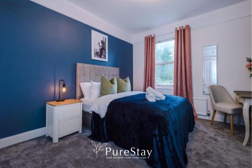 a blue bedroom with a bed and a desk at Incredible 5 Bedroom House with 7 actual Beds By PureStay - 3 min walk to Central Bath in Bath