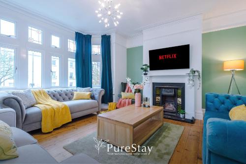 a living room with a couch and a fireplace at Incredible 5 Bedroom House with 7 actual Beds By PureStay - 3 min walk to Central Bath in Bath