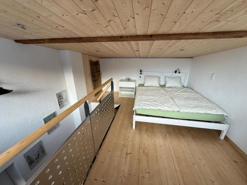 a bedroom with a bed and a wooden ceiling at Bed&Cheese Deggio in Quinto