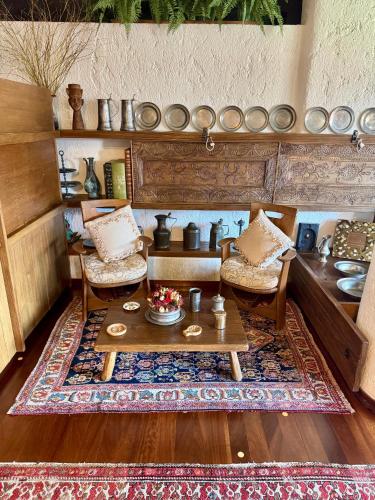 a living room with a coffee table and chairs at Elegant Apartment with center and Tofana view in Cortina dʼAmpezzo