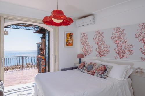 a bedroom with a bed with a view of the ocean at POSEA Collection - Villa Ponente in Positano