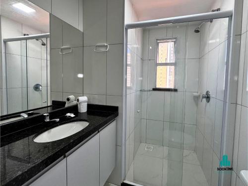 a bathroom with a sink and a glass shower at Aquarius Residence by Holiday Stays in Fortaleza