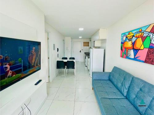 a living room with a blue couch and a kitchen at Aquarius Residence by Holiday Stays in Fortaleza