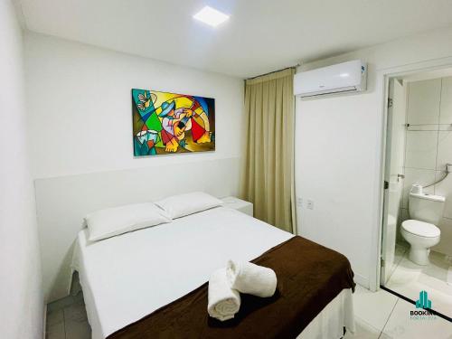 a hotel room with a bed and a bathroom at Aquarius Residence by Holiday Stays in Fortaleza