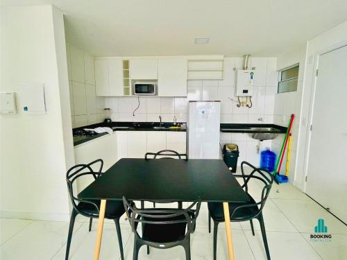 a kitchen with a black table and chairs in it at Aquarius Residence by Holiday Stays in Fortaleza