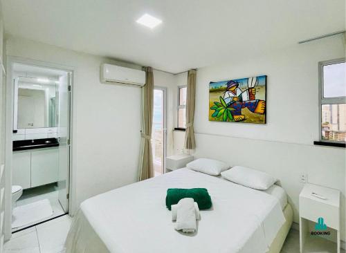 a white room with a bed and a bathroom at Aquarius Residence by Holiday Stays in Fortaleza