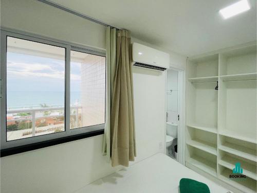 a bathroom with a window with a view of the ocean at Aquarius Residence by Holiday Stays in Fortaleza