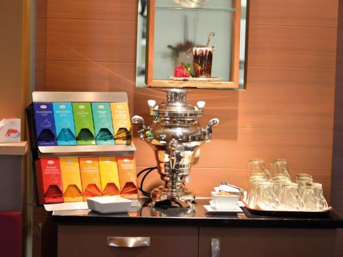 a table with a trophy and books on it at Prinzhotel Rothenburg in Rothenburg ob der Tauber
