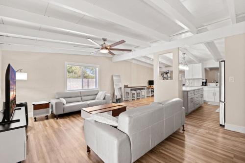 a living room with a couch and a ceiling fan at Luxury Mid-Century Modern 3-Bedroom Home in Phoenix
