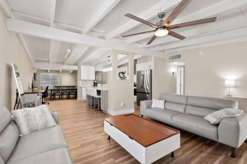 a living room with a couch and a ceiling fan at Luxury Mid-Century Modern 3-Bedroom Home in Phoenix