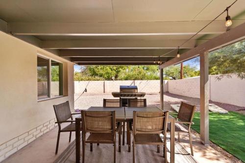 a dining table and chairs on a patio at Luxury Mid-Century Modern 3-Bedroom Home in Phoenix