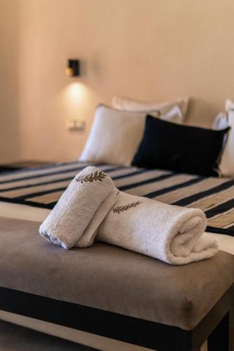 a towel sitting on top of two beds at Villa Anna - Havre de paix in Oulad Ikhia