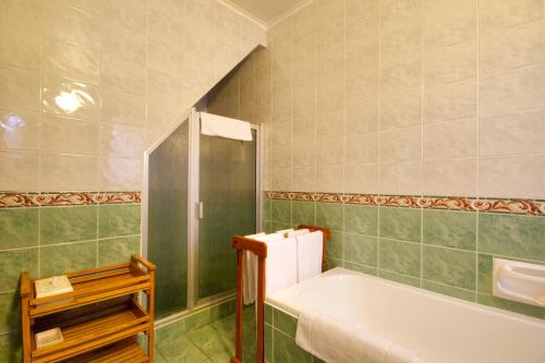 a bathroom with a tub and a shower at St. Lucia Wetlands Guest House in St Lucia