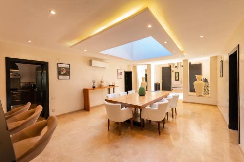 a dining room with a table and chairs at Villa Anna - Havre de paix in Oulad Ikhia