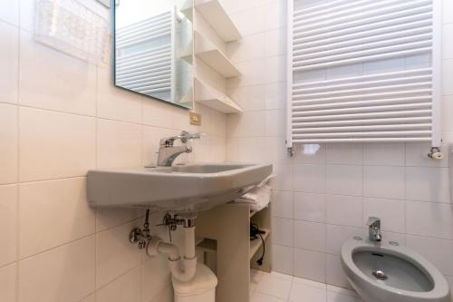 a bathroom with a sink and a toilet at Ciasa al Sol in Falcade
