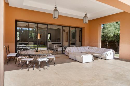 a living room with a couch and a table at Villa Anna - Havre de paix in Oulad Ikhia
