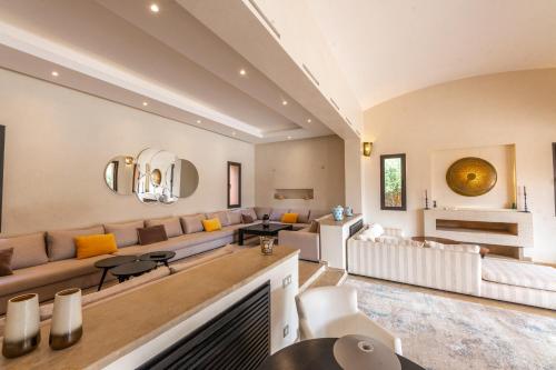a living room with a couch and a table at Villa Anna - Havre de paix in Oulad Ikhia