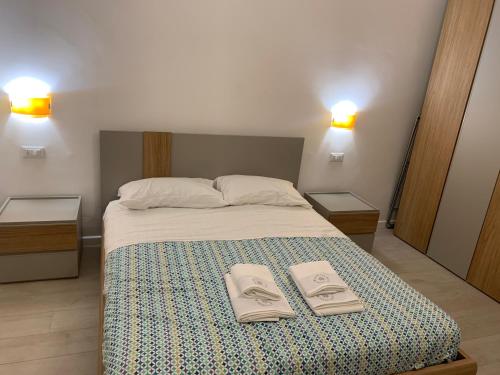a bedroom with a bed with two towels on it at Dimoraalporto in Civitavecchia