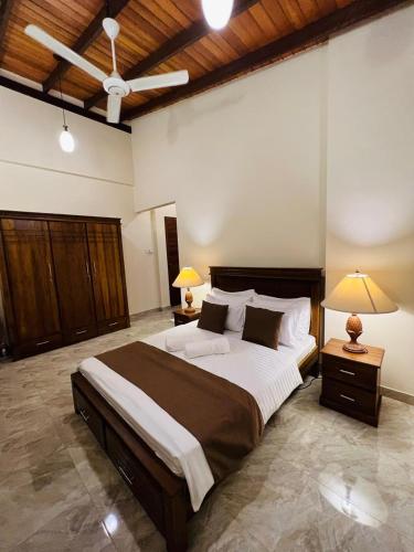 a large bedroom with a large bed with two lamps at Uyana View in Moratuwa
