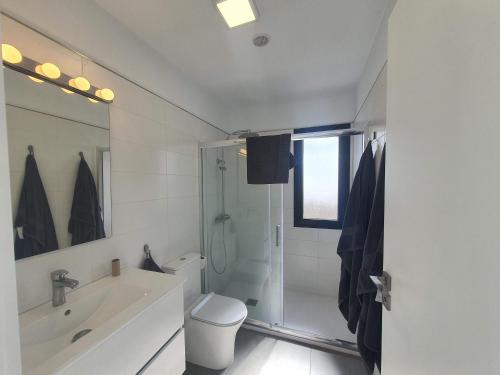 a bathroom with a shower and a toilet and a sink at Casa Camino Real in Los Barros
