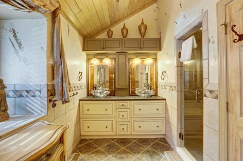 a bathroom with a shower and a sink and a tub at The Rusty Nail in Oakland