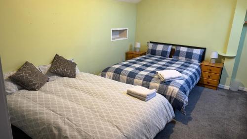 a bedroom with two beds and two night stands at Cosy 3 bed bungalow in Dublin in Lucan