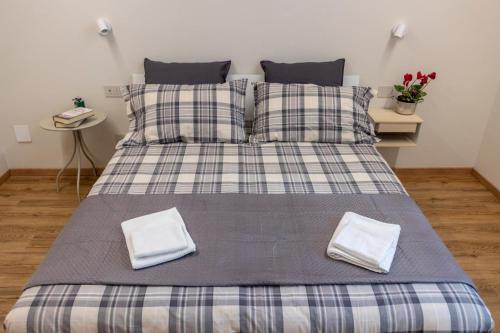 a bed with two pillows on it in a room at Casa Belfiore, Darfo Boario Terme Ospitar in Boario Terme