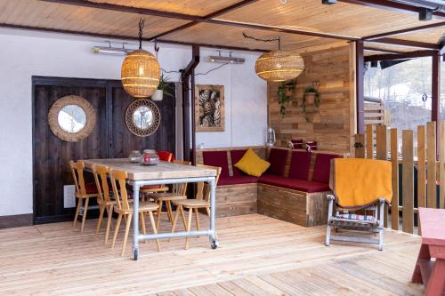 a dining room with a table and chairs at Bergvilla Vivaldi - Happy Mountain Vibes in Mühlbach am Hochkönig