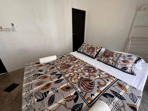 a bed with two pillows on it in a room at Mahaon surf hotel in Weligama
