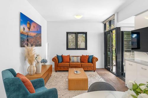a living room with a couch and a table at More Room, Up Top A Sepal Stay in Perth
