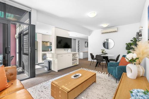 a living room with a couch and a table at More Room, Up Top A Sepal Stay in Perth