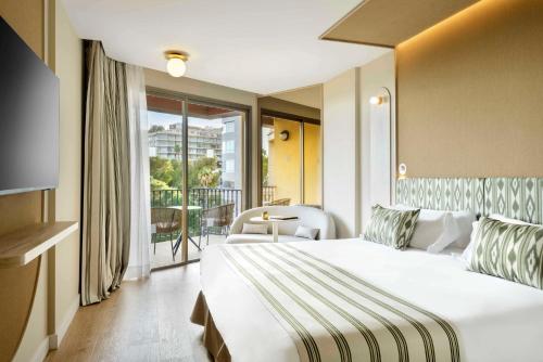 a hotel room with a bed and a balcony at Barceló Illetas Albatros - Adults Only in Illetas