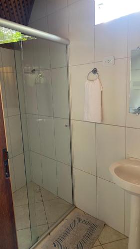 a bathroom with a shower and a sink at Chalé Esmeralda in Ouro Preto