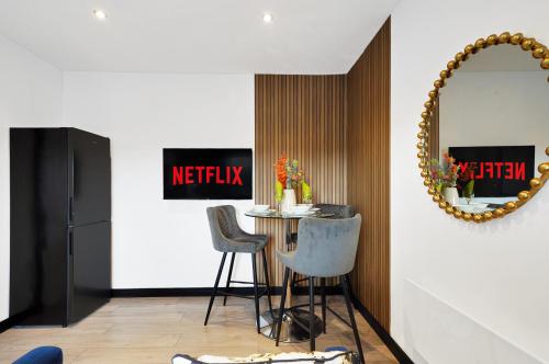a dining room with a table and a mirror at Boutique and Beautiful Flat in Yorkshire - Top Floor in Castleford