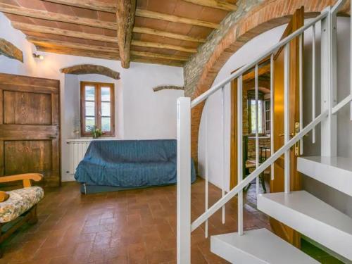 a living room with a blue couch and stairs at FATTORIA L'OTTAVO l'8 LARGE WINE AND OIL PRODUCERS in Lucolena in Chianti