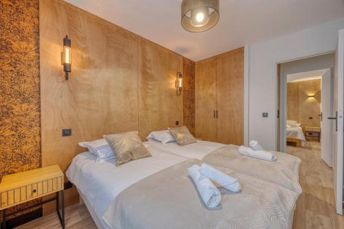 a bedroom with two beds with towels on them at Le 18 Prévost - Square in Fontaine