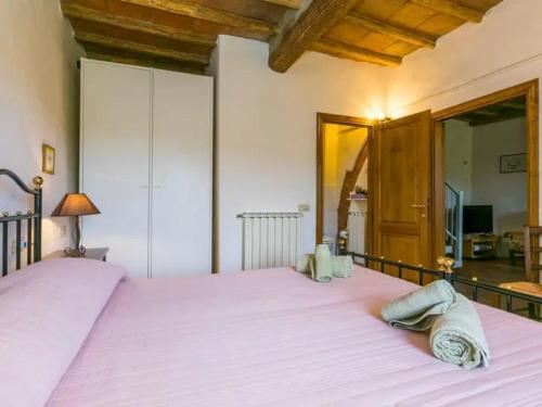 a bedroom with a large bed with two towels on it at FATTORIA L'OTTAVO l'8 LARGE WINE AND OIL PRODUCERS in Lucolena in Chianti