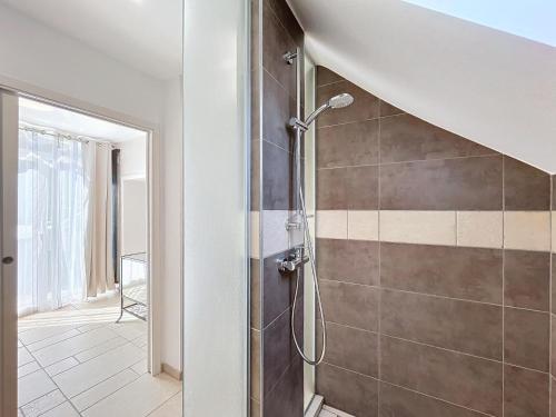 a bathroom with a shower with a glass door at Le relais des Forges in Sprimont