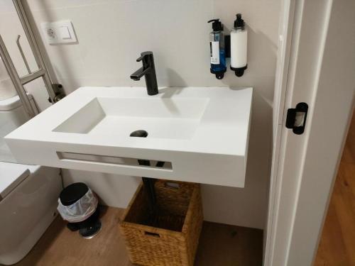 a bathroom with a white sink in a room at Apartamentos Molinos in Constantina