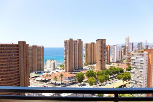 a view of a city with tall buildings and the ocean at Dynastic Rooms Apartments in Benidorm