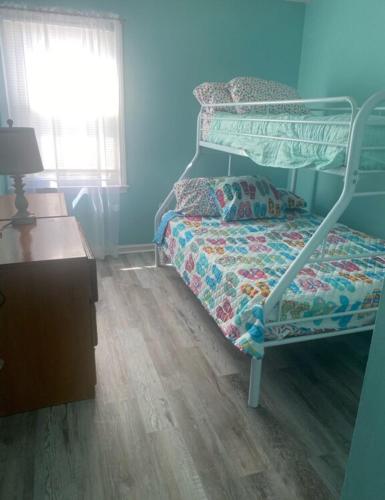 a bedroom with a bunk bed and a wooden floor at 2 bedroom garden city ocean front in Myrtle Beach