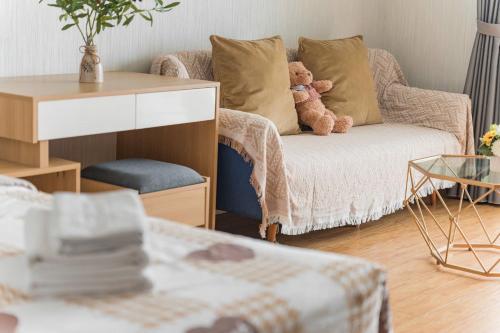 a living room with a couch with two teddy bears on it at HN ETH Vinhomes D'capitale Resident - Tran Duy Hung St in Hanoi