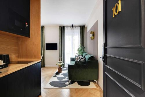 une cuisine avec une porte noire et un salon dans l'établissement Entire apartment near the Eiffel Tower, à Paris