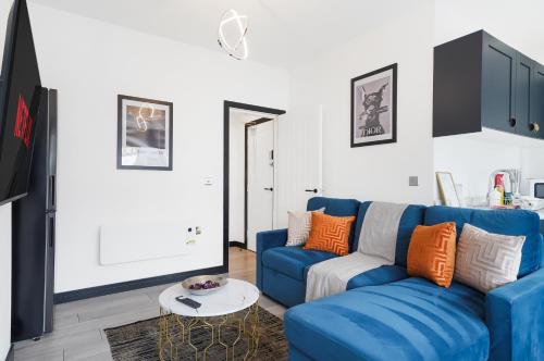 a living room with a blue couch and a table at 30 percent off! Boutique Yorkshire Gem - Sleeps 4 in Castleford