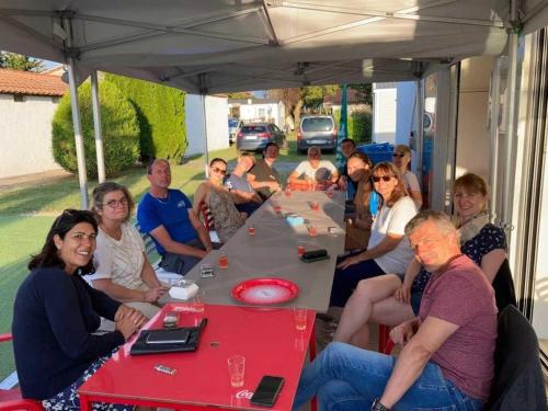 a group of people sitting under a tent at Camping 3 étoiles - Piscine - ccaihff in Saint-Georges-de-Didonne