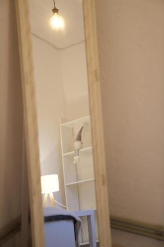 a mirror in a room with a table and a lamp at Holiday House LIL Home in Krāslava