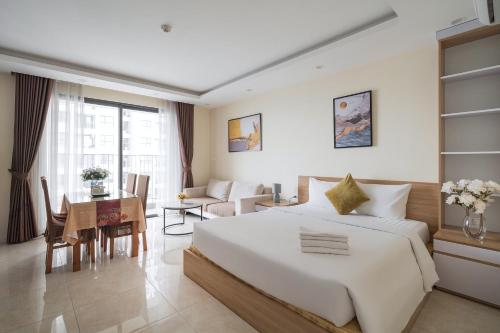 a bedroom with a large bed and a dining room at HN ETH Vinhomes D'capitale Resident - Tran Duy Hung St in Hanoi