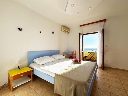 a bedroom with a bed with a view of the ocean at Apartments Kiro in Milna